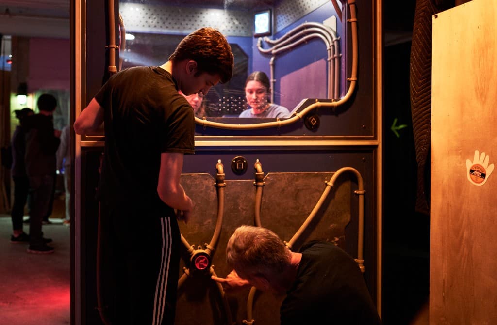 Guests exploring a control panel at Edge of Elsewhere